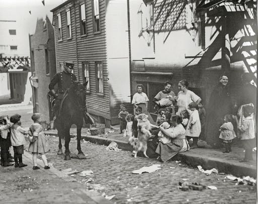 Looking down Foster Street (our street, from Commercial) from about halfway up the hill. The clapboard building behind the horse in the top photo no longer exists; the two brick structures remain.